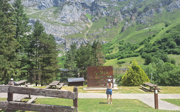 Visitor at Fuente Dé sign in Picos de Europa National Park, Cantabria, Spain, near cable car station.