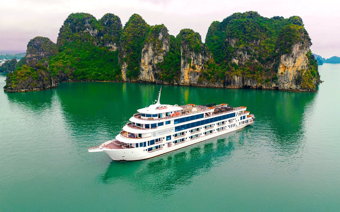 Aerial view of Ambassador cruise ship in Halong Bay, Vietnam, near limestone islands.