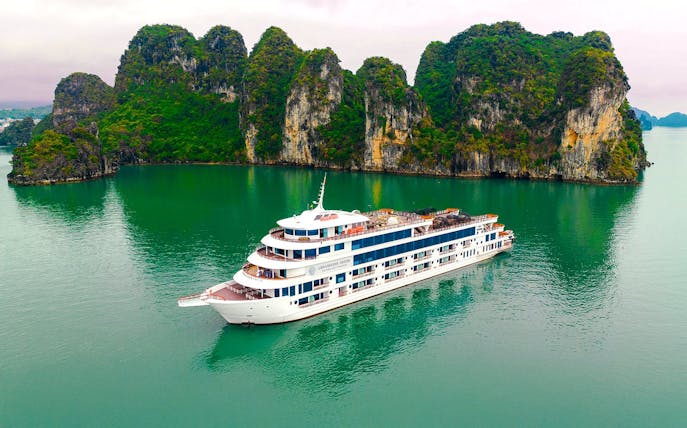 Aerial view of Ambassador cruise ship in Halong Bay, Vietnam, near limestone islands.
