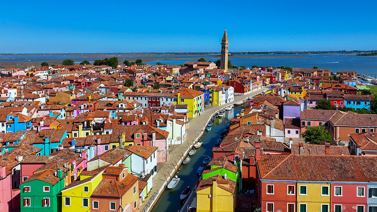 Aerial view of colorful Burano Islands and Torcello, Venice, Italy, showcasing vibrant buildings and canals.