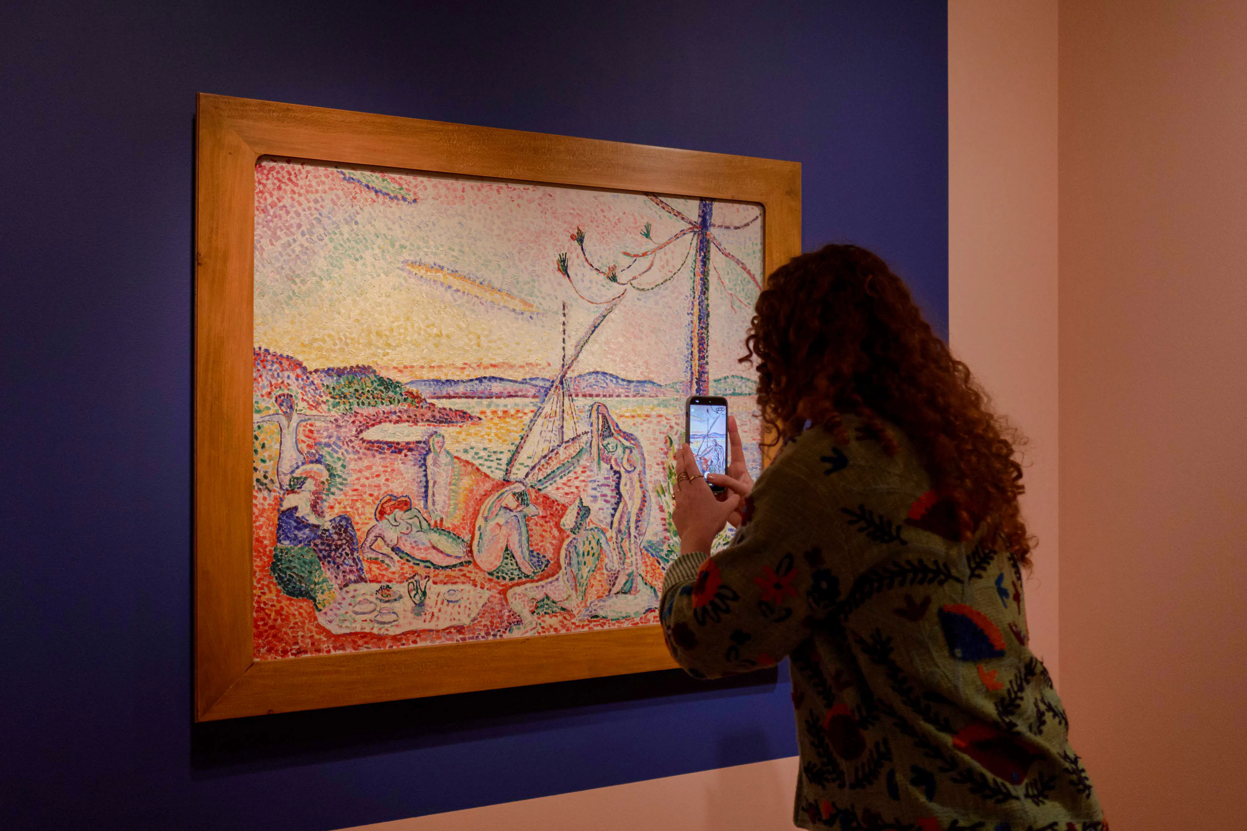 Visitor photographing a painting at Chez Matisse exhibit, Amsterdam.