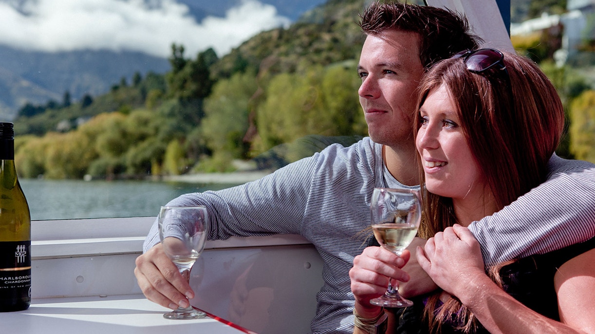 Lake Wakatipu cruise boat with scenic mountain backdrop, Queenstown, New Zealand.