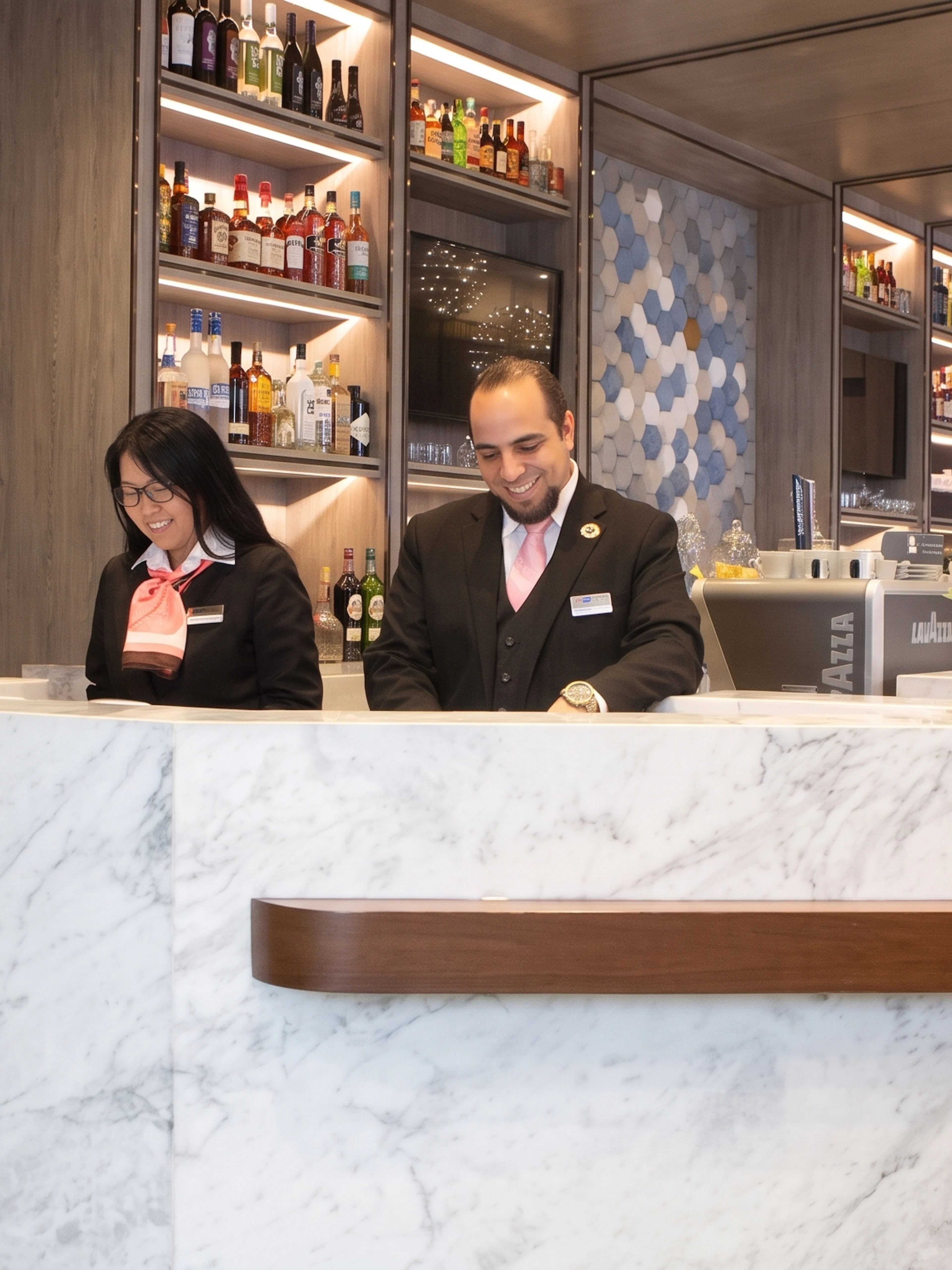 Staff at reception desk in Plaza Premium Lounge, Dallas Fort Worth International Airport Terminal E.