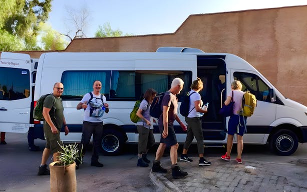 Travelers boarding a van for Agafay Desert tour in Marrakech.