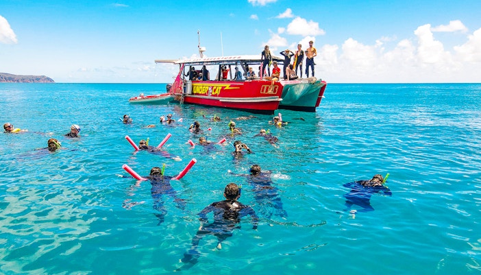 Snorkelers near Thundercat boat in Whitsundays, Australia, enjoying a full day tour.