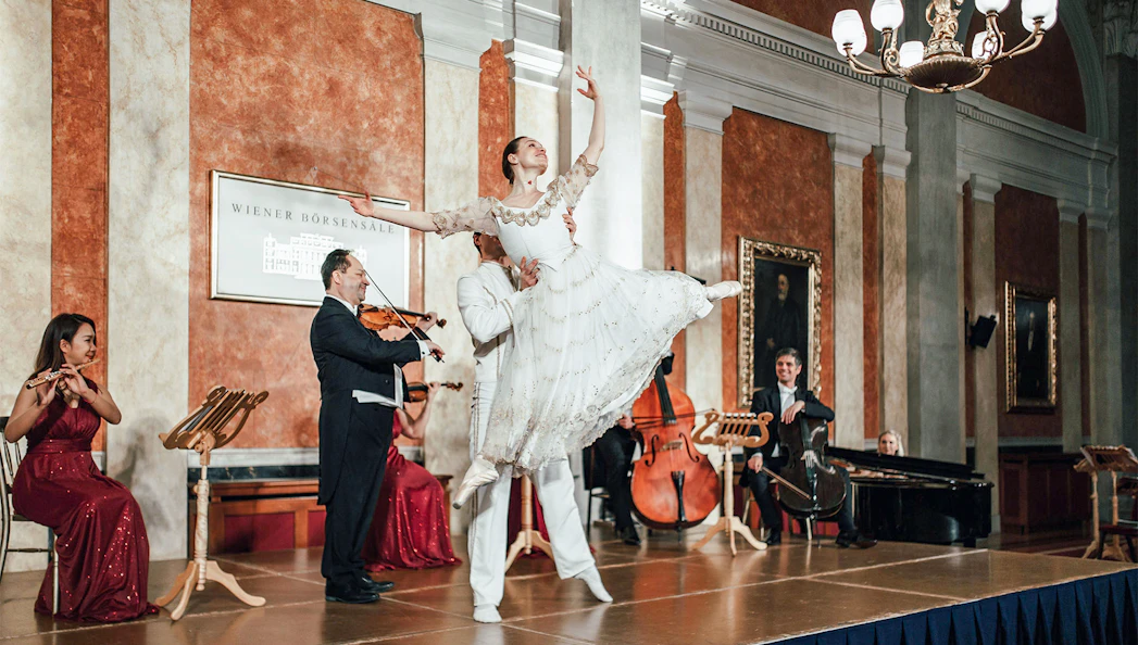 Vienna Residence Orchestra performing with ballet dancer at Old Stock Exchange Palace.