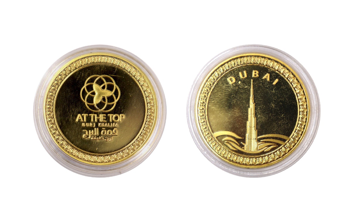 Gold coin featuring Burj Khalifa and "At The Top" logo, Dubai.