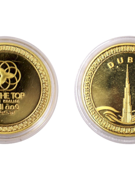 Gold coin featuring Burj Khalifa and "At The Top" logo, Dubai.