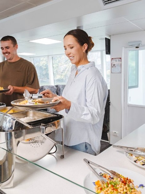 Guests enjoying buffet on Milford Sound nature cruise ship.