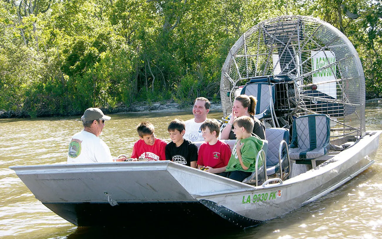 Group enjoying airboat tour through New Orleans swamp.