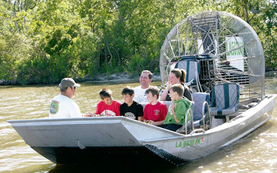 Group enjoying airboat tour through New Orleans swamp.