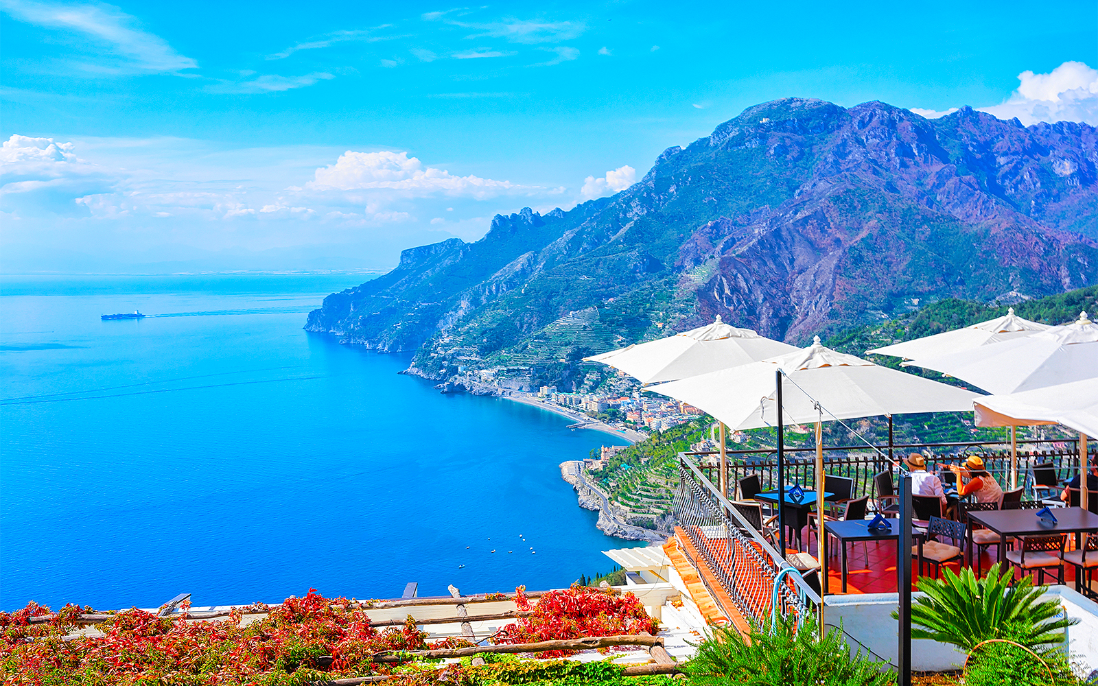Dining area with tables and chairs overlooking the Amalfi Coast, Rome to Positano route.