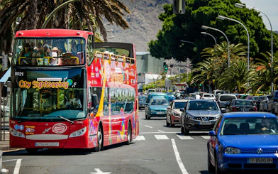 Open-top sightseeing bus touring Santa Cruz city streets.