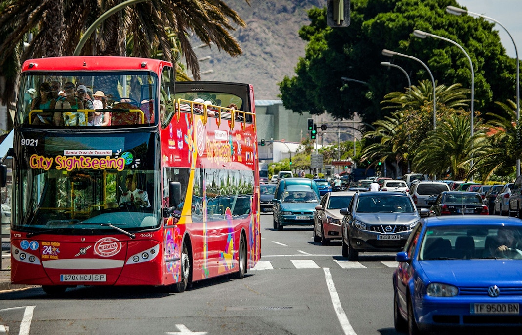 Open-top sightseeing bus touring Santa Cruz city streets.
