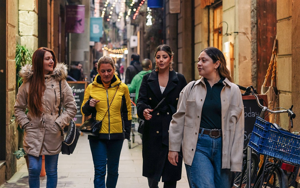 Group walking through a narrow street in Barcelona during a guided tour.