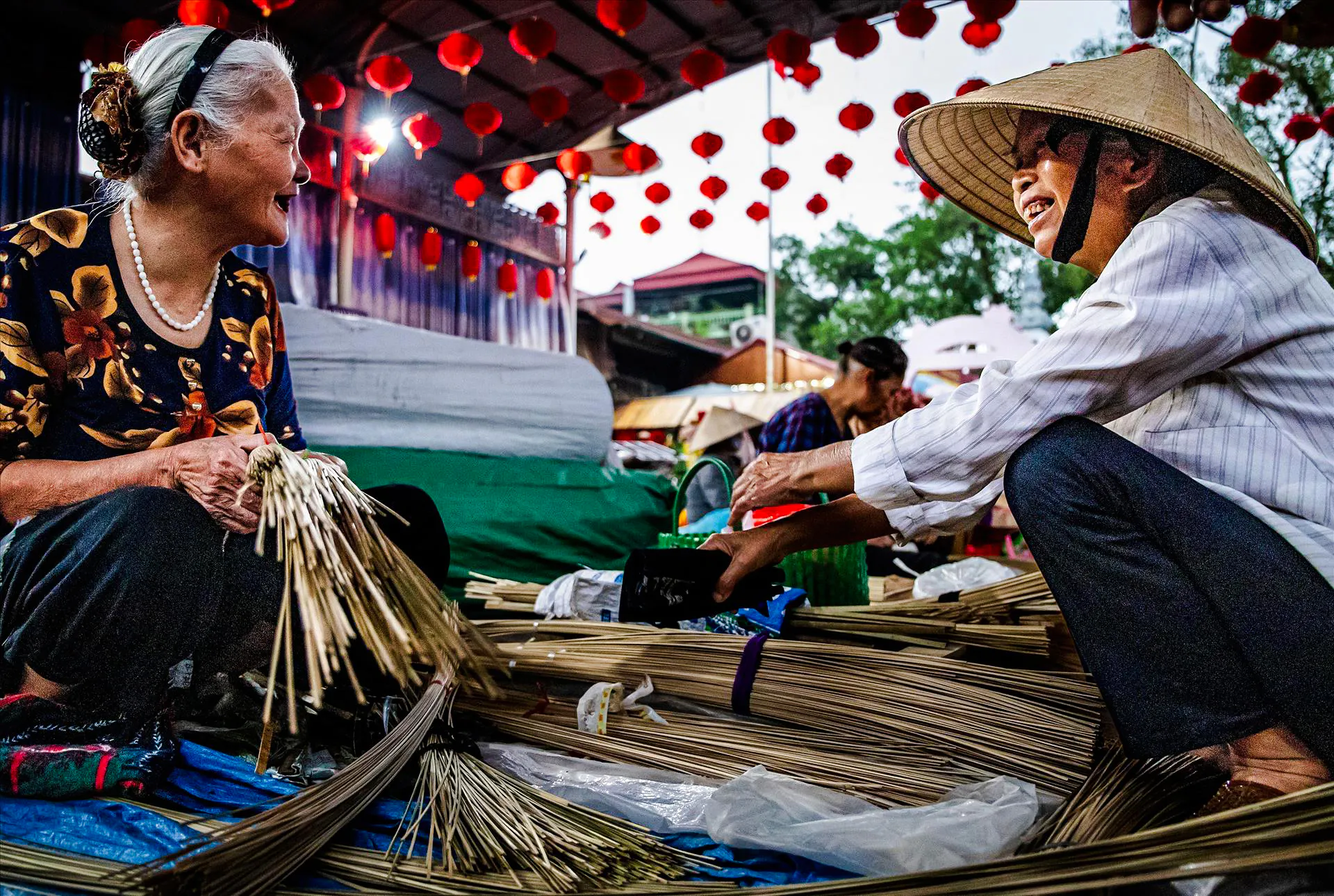 Craftspeople making incense sticks at a market in Hanoi's Incense Village.