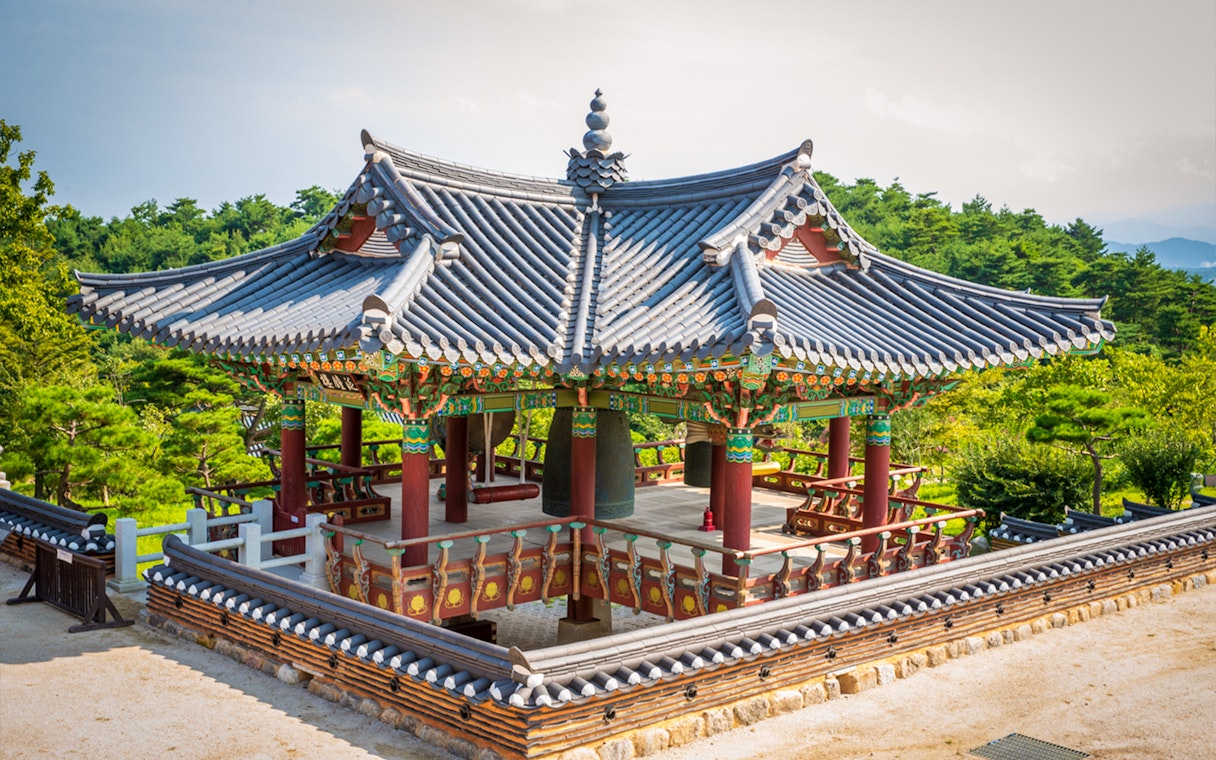 Naksansa Temple pavilion with traditional architecture near Mt. Seorak, surrounded by greenery.
