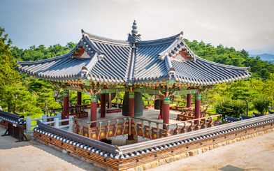 Naksansa Temple pavilion with traditional architecture near Mt. Seorak, surrounded by greenery.