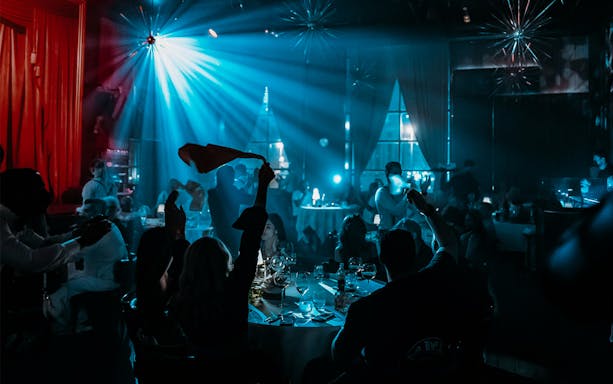 Guests enjoying live entertainment and dining at Billionaire Dubai.