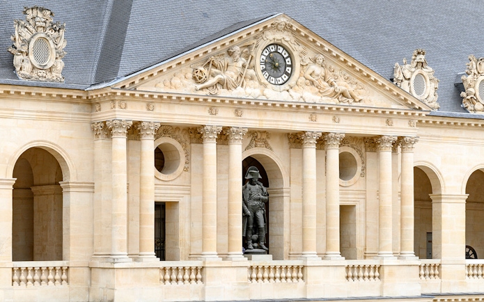 Facade of the Army Museum in Paris with Napoleon statue.