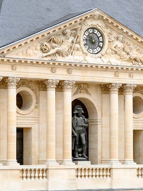 Facade of the Army Museum in Paris with Napoleon statue.