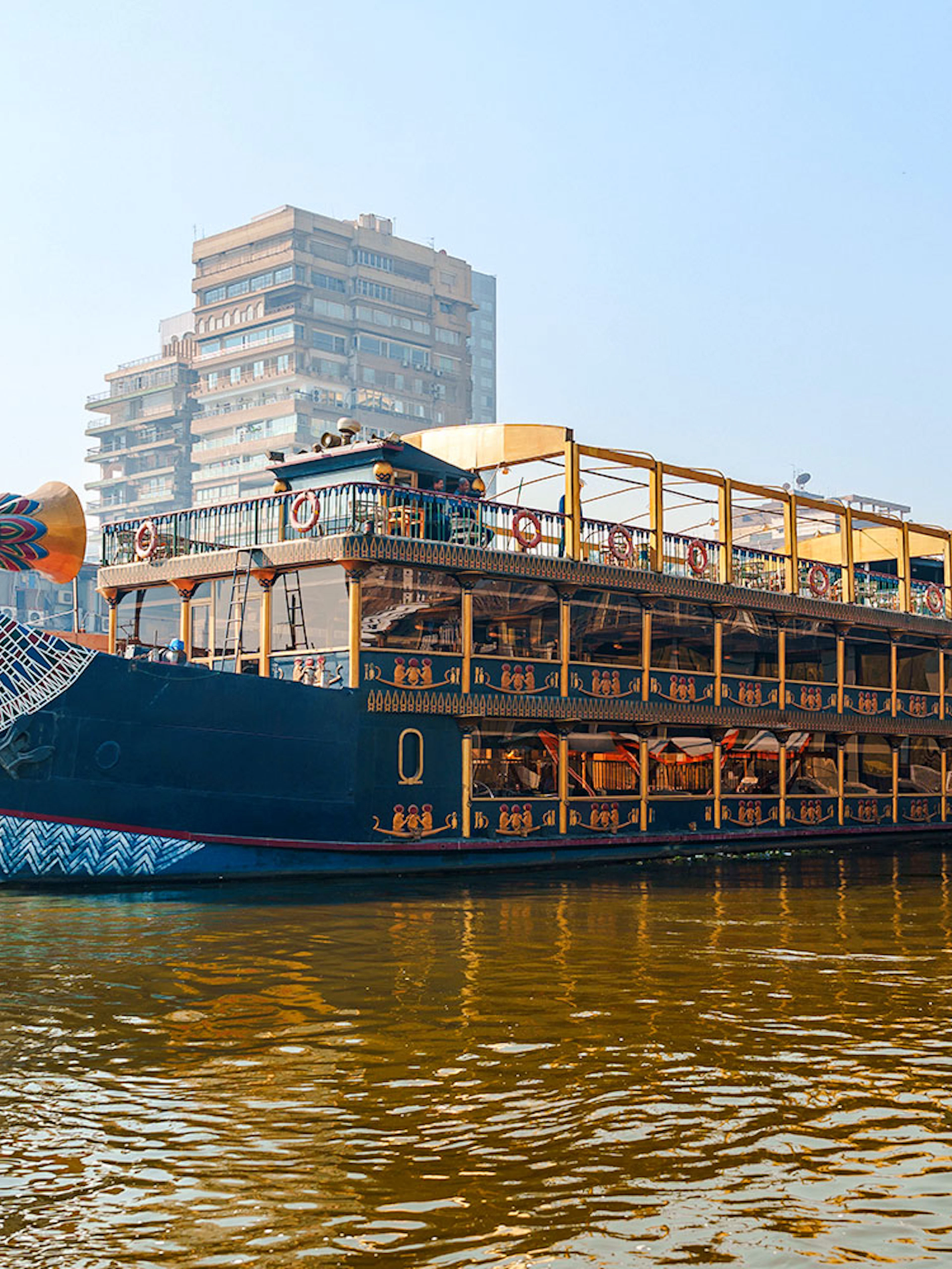 Nile cruise ship with pharaoh-themed decor docked in Cairo, Egypt.
