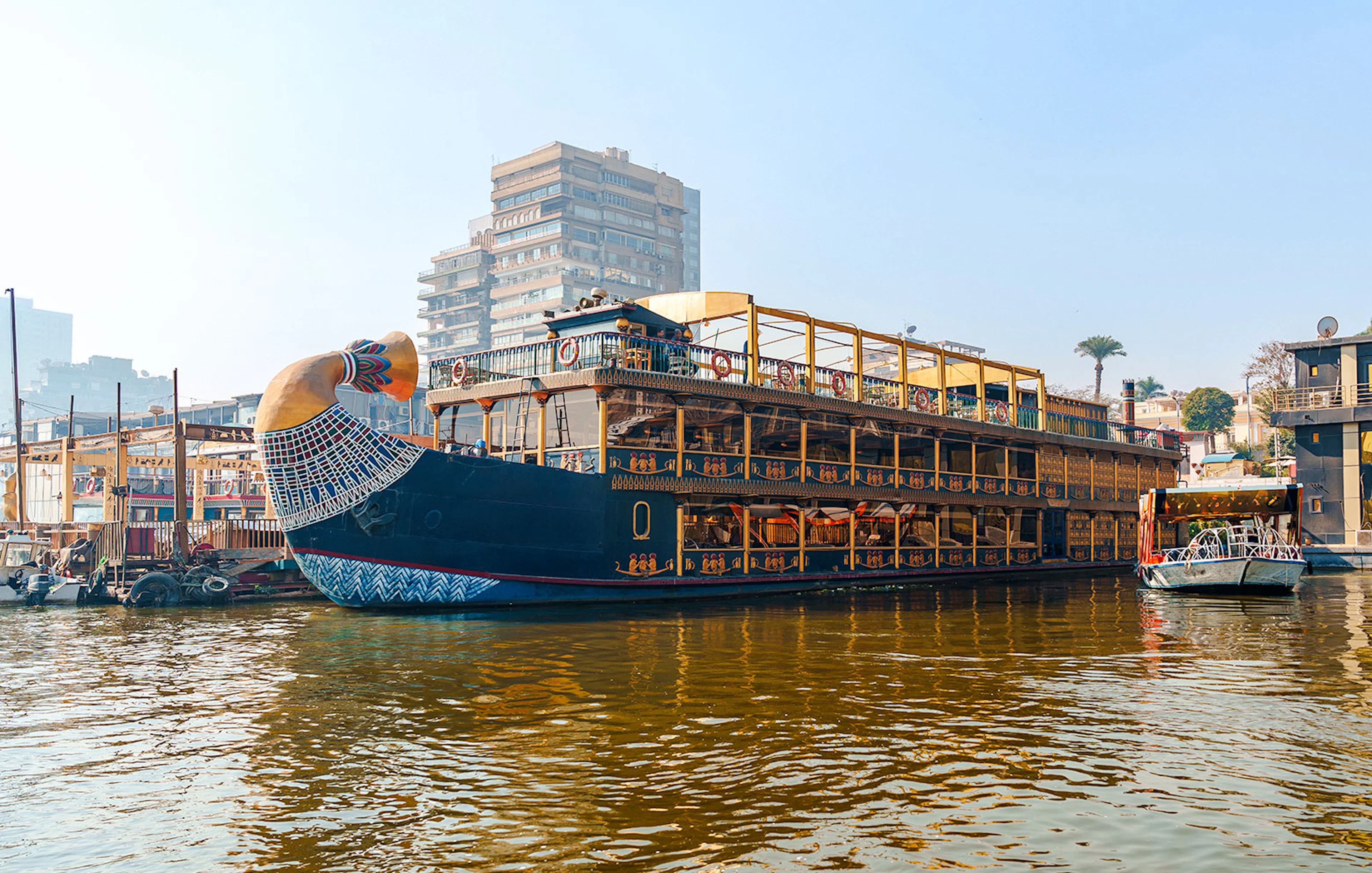 Nile cruise ship with pharaoh-themed decor docked in Cairo, Egypt.
