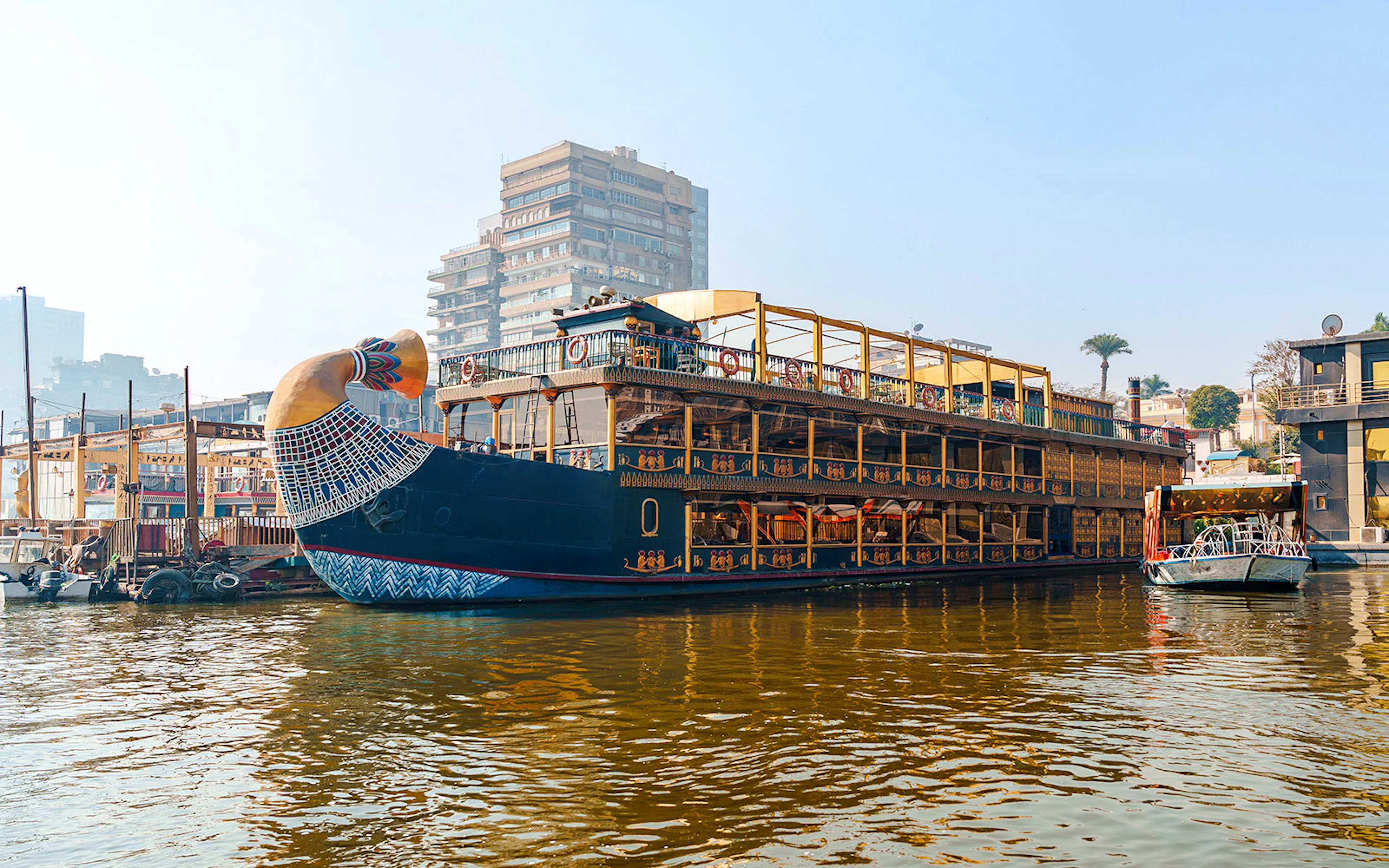 Nile cruise ship with pharaoh-themed decor docked in Cairo, Egypt.