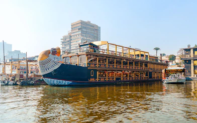 Nile cruise ship with pharaoh-themed decor docked in Cairo, Egypt.