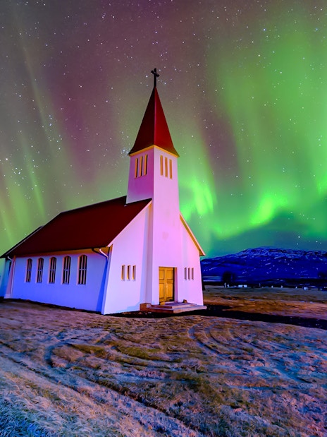 Vikurkirkja church under northern lights, Reykjavik.