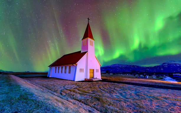 Vikurkirkja church under northern lights, Reykjavik.