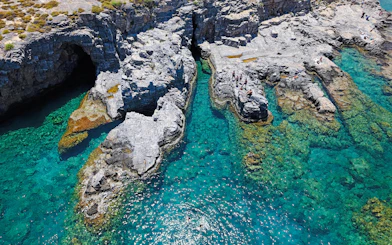 Cliffs and clear turquoise waters at Lindos Bay, Greece.