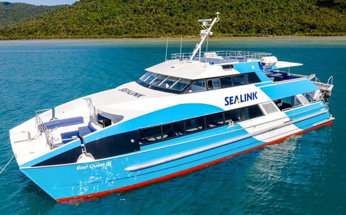 Cruise boat on turquoise waters near Airlie Beach, Hill Inlet Lookout tour.