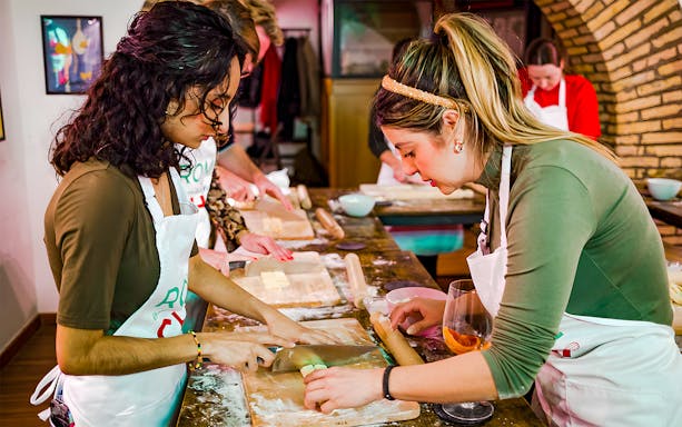 Participants preparing pasta at Spritz & Spaghetti Tipsy Cooking Class, Rome.