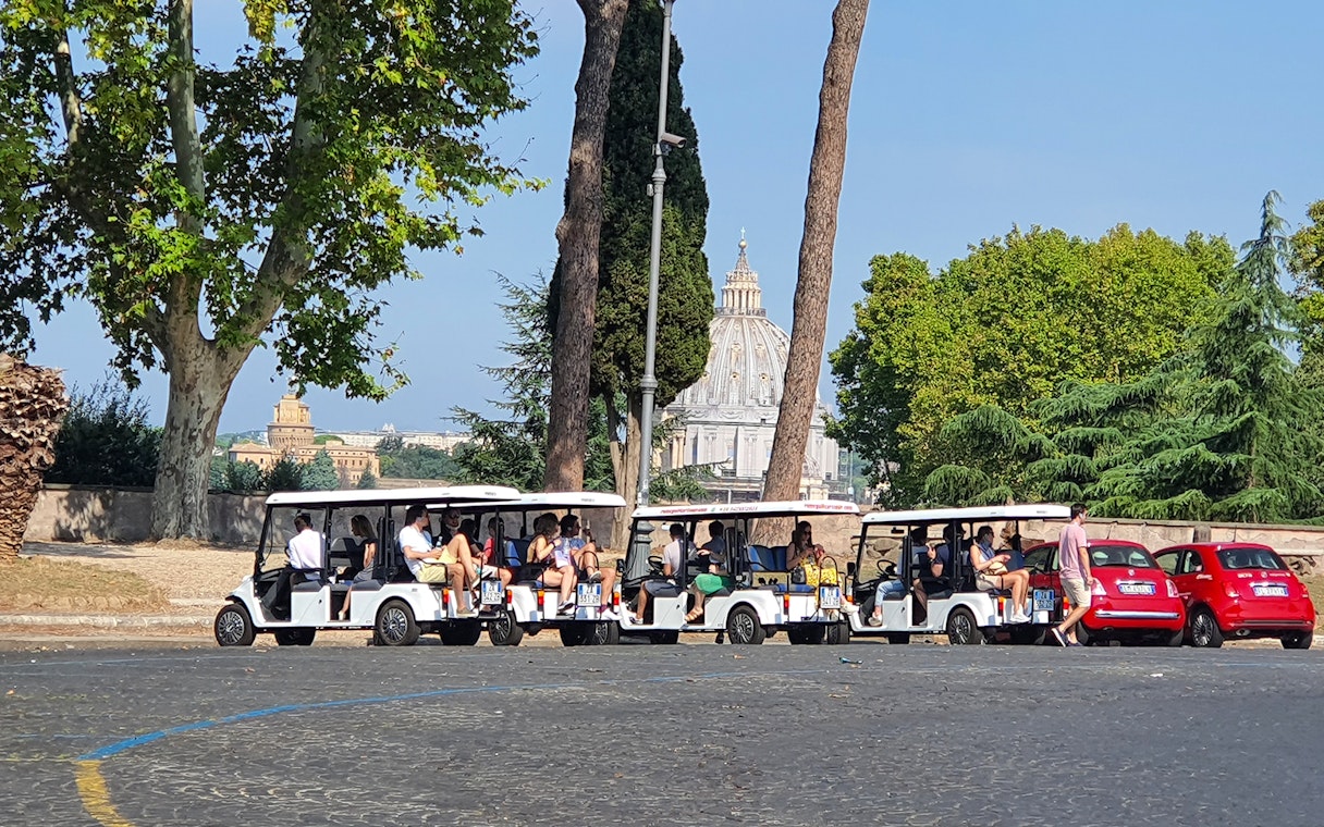 Tourists on golf carts near St. Peter's Basilica, Rome.
