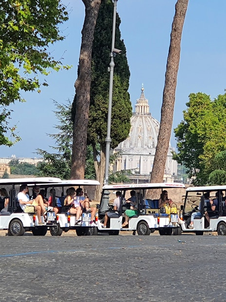 Tourists on golf carts near St. Peter's Basilica, Rome.