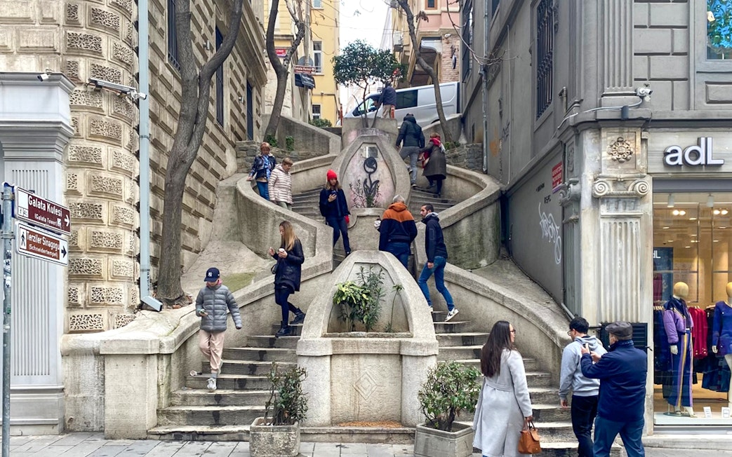 Kamondo Stairs in Istanbul with people walking and exploring the historic site.