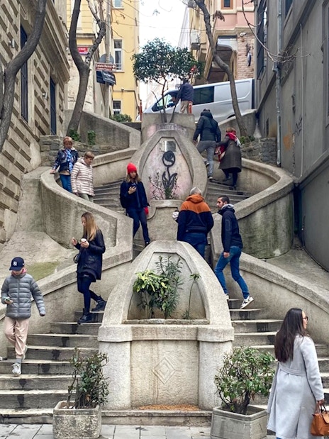 Kamondo Stairs in Istanbul with people walking and exploring the historic site.
