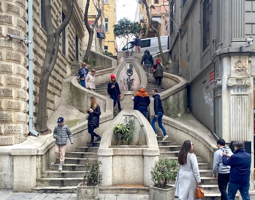 Kamondo Stairs in Istanbul with people walking and exploring the historic site.