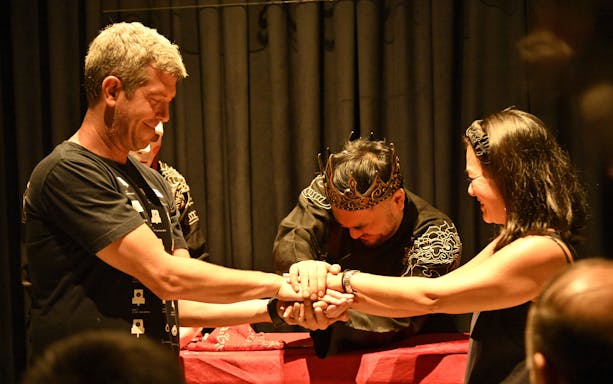 Magician performing a trick with audience members at Mystic Night Show in Ho Chi Minh City.