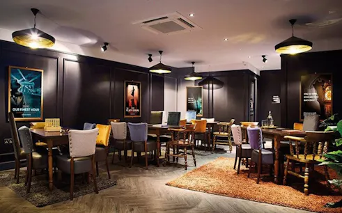 Escape room setup with tables and chairs at Dubai Indoor Adventure.