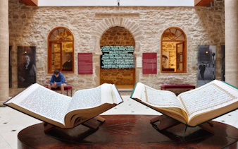Open books on display at Bayt Dakira in Essaouira, showcasing cultural heritage.
