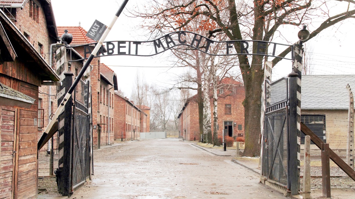 Auschwitz-Birkenau guided tour group exploring historical site in Krakow, Poland.