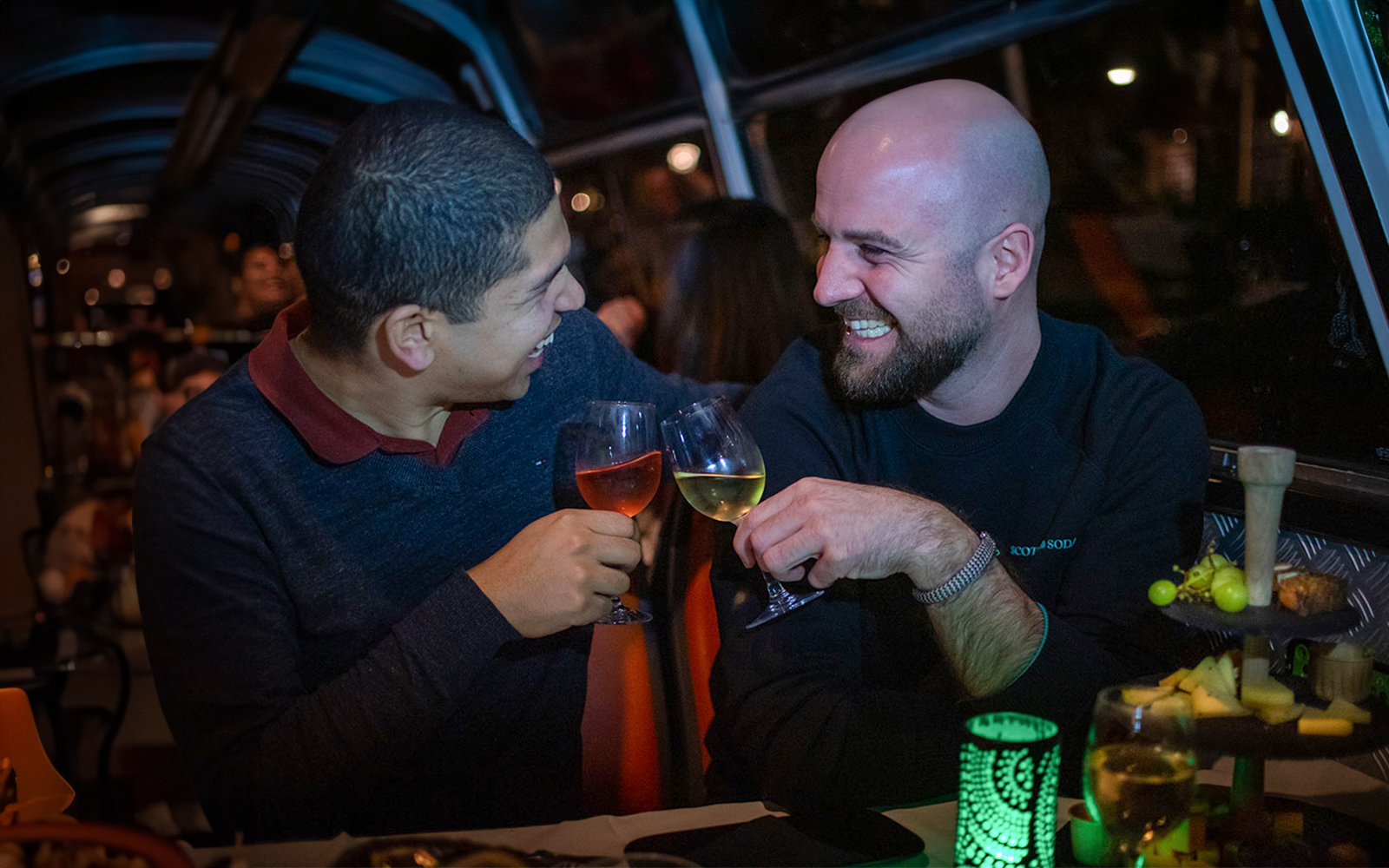 Couple enjoying wine and cheese on an Amsterdam canal cruise.
