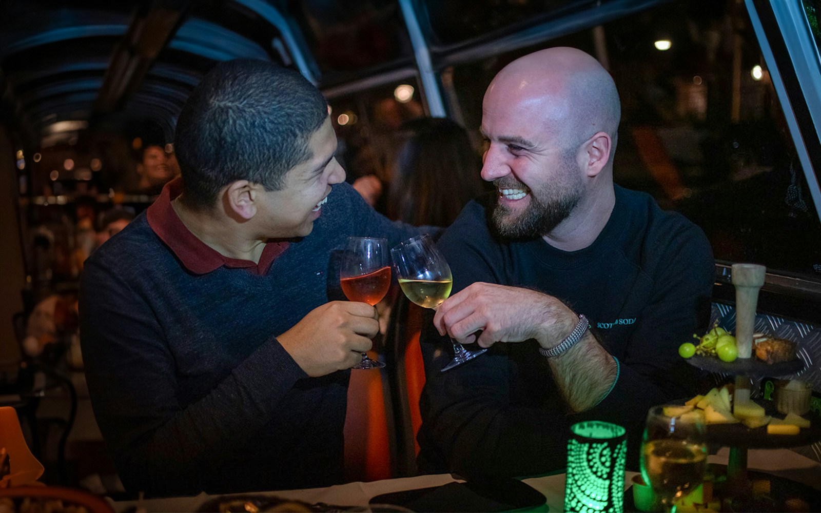 Couple enjoying wine and cheese on an Amsterdam canal cruise.