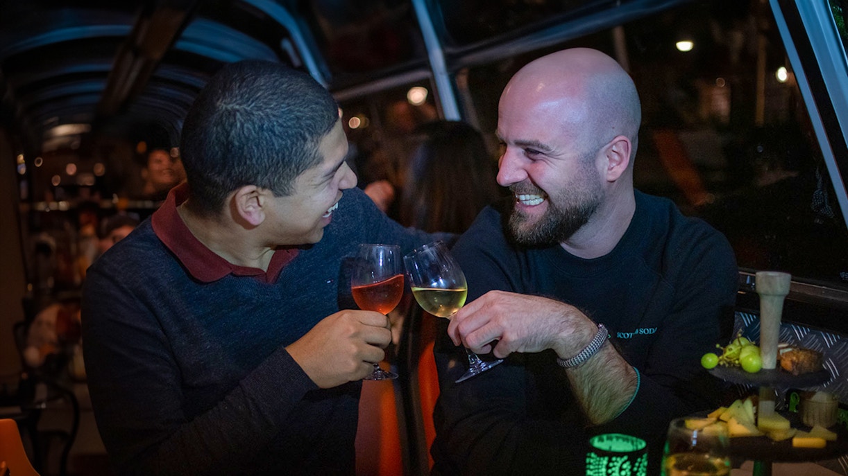 Couple enjoying wine and cheese on an Amsterdam canal cruise.