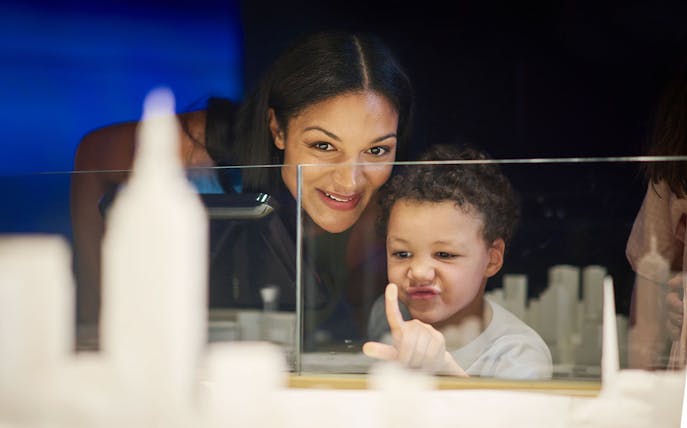 Child and adult exploring Melbourne Skydeck model during Ultimate Skydeck Experience.