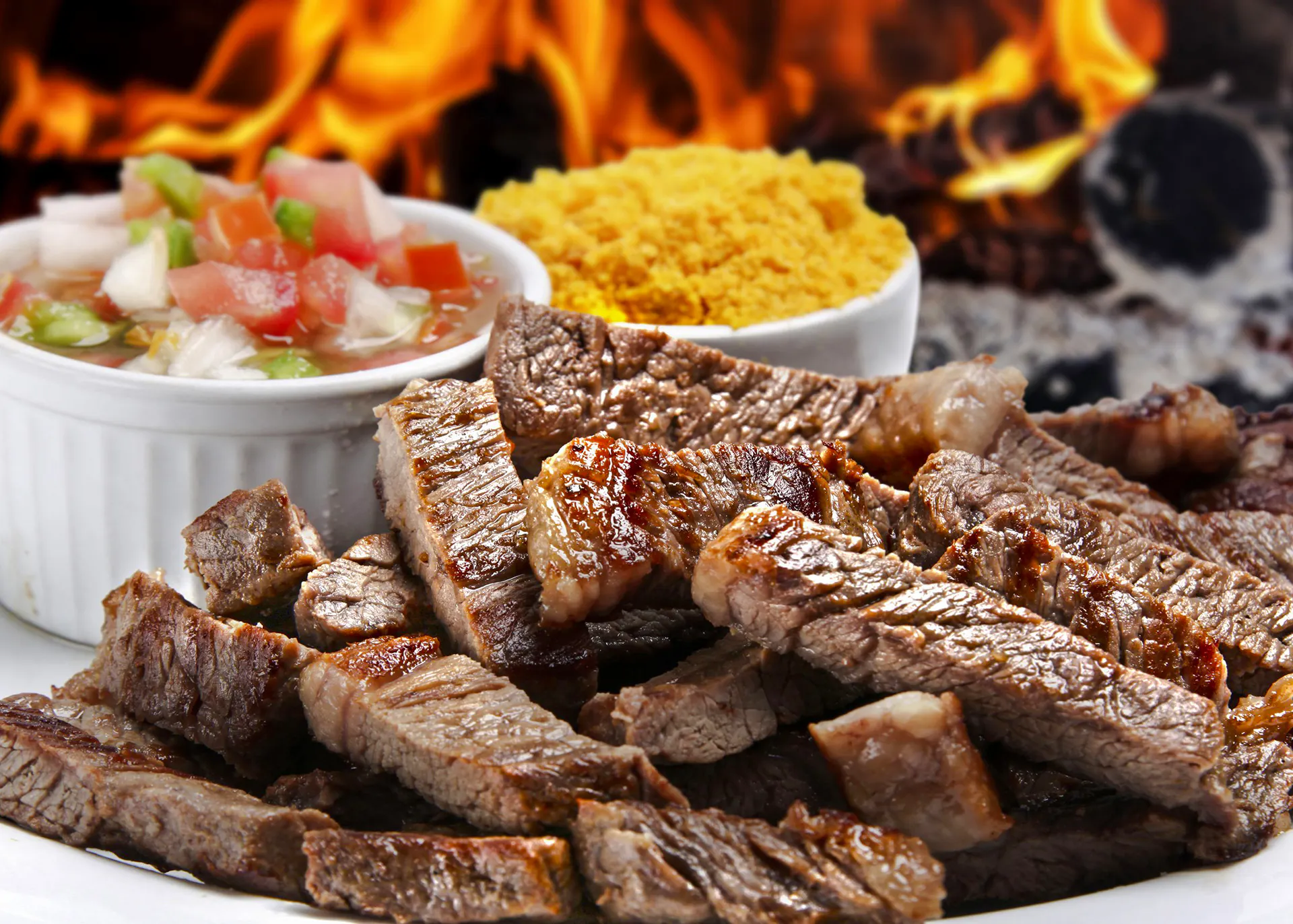 Grilled meat with sides at a Brazilian steakhouse in Rio de Janeiro.