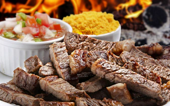 Grilled meat with sides at a Brazilian steakhouse in Rio de Janeiro.