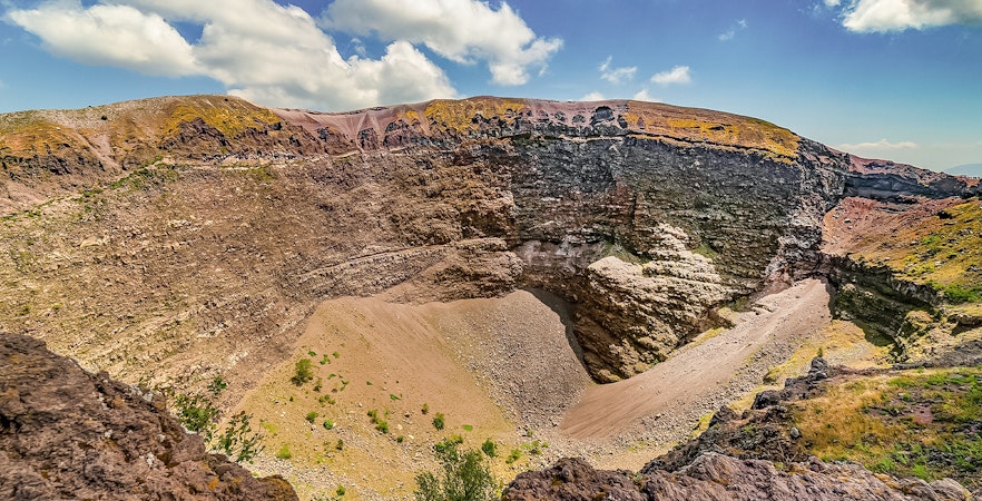 Mount Vesuvius crater with rocky terrain and clear sky in Naples, Italy.